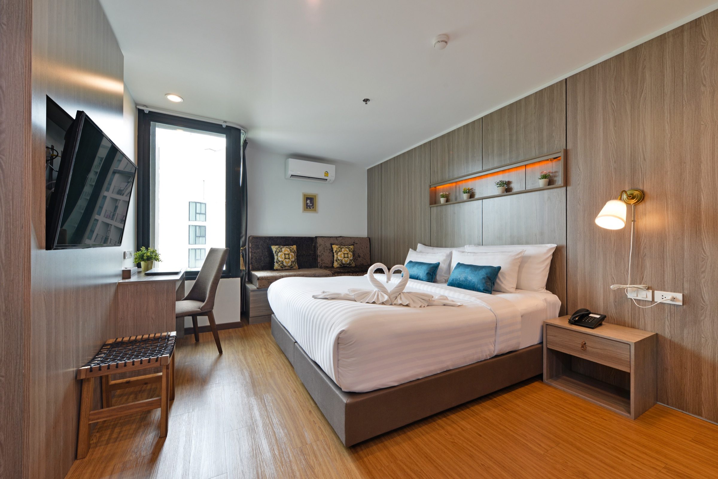 A Deluxe King room at StayAt Bedever with a king bed and a sofa seating corner