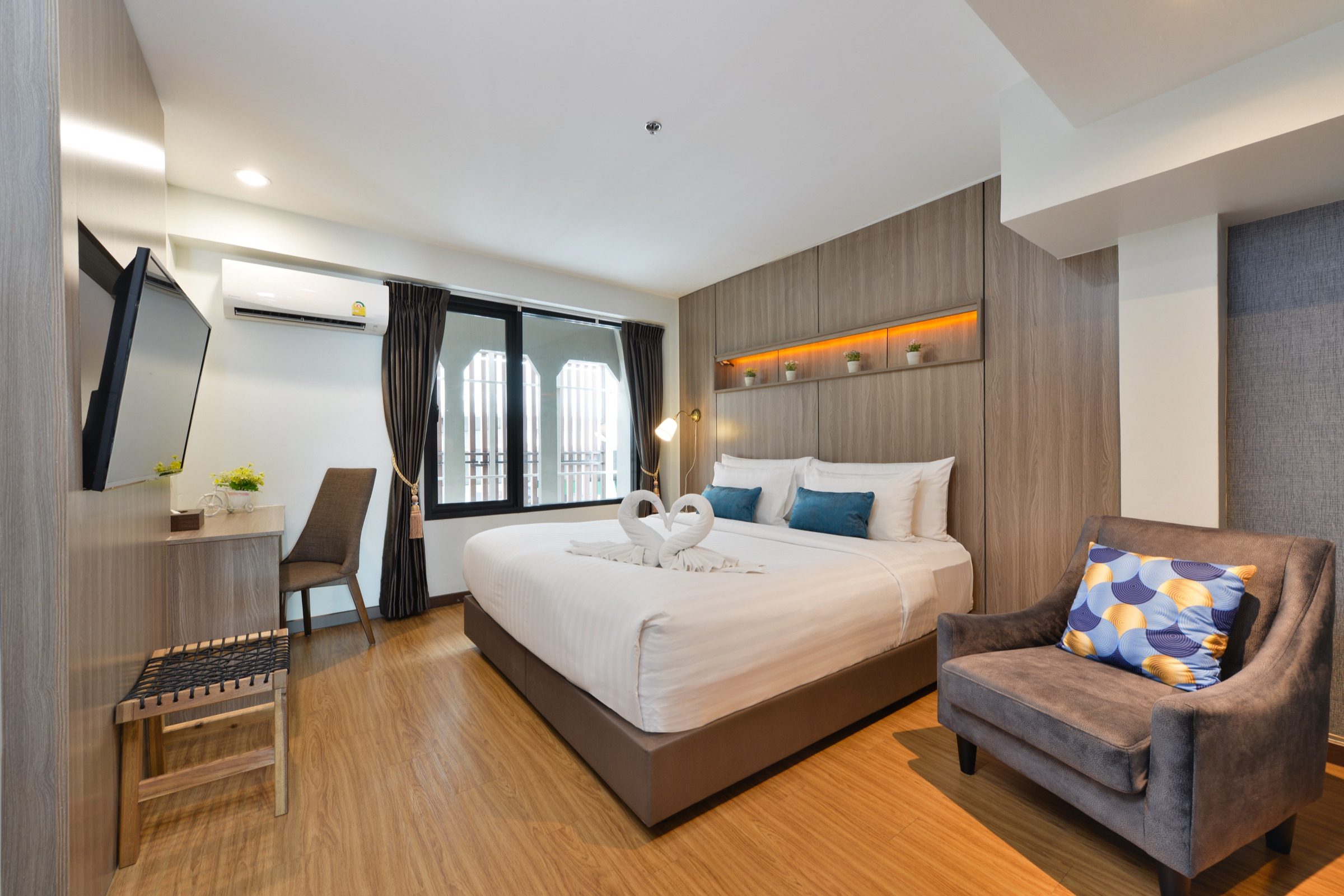 A Superior King room at StayAt Bedever with a king bed, wooden floors, a desk and an armchair by the window
